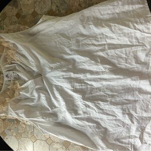 White Sleeveless Blouse with Ruffle Detail